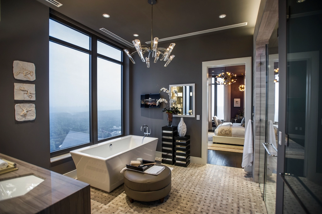 Dramatic dark bathroom with a freestanding tub