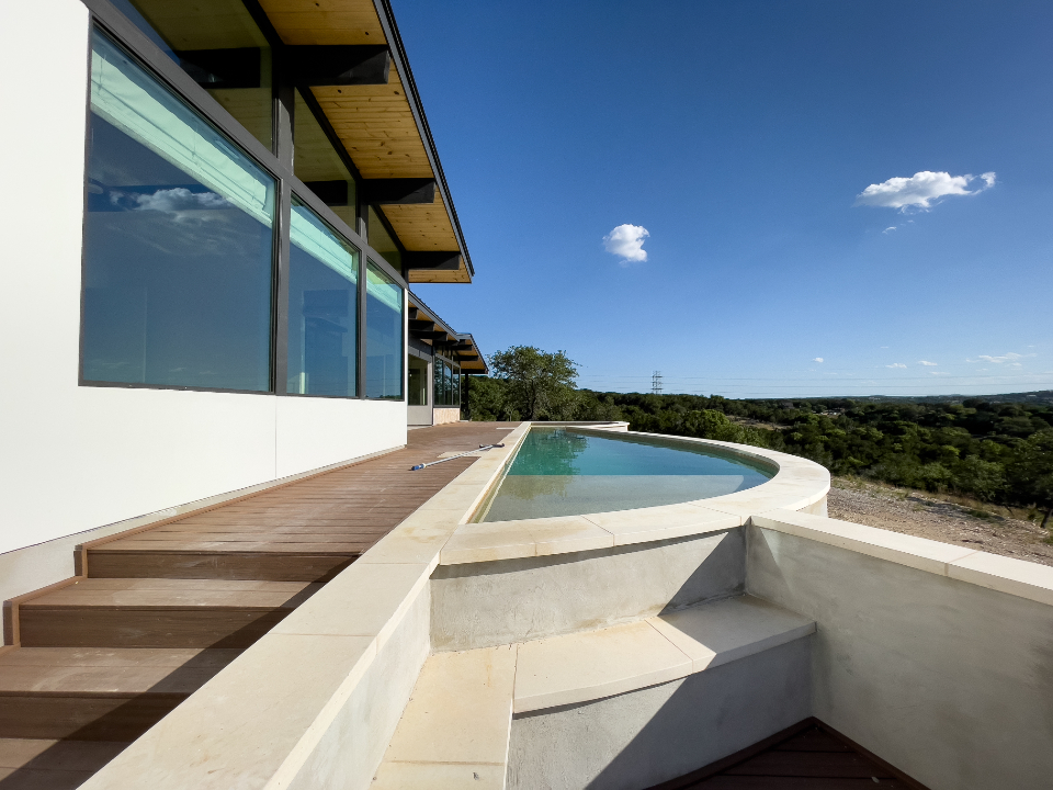 Modern home with an infinity pool overlooking hills